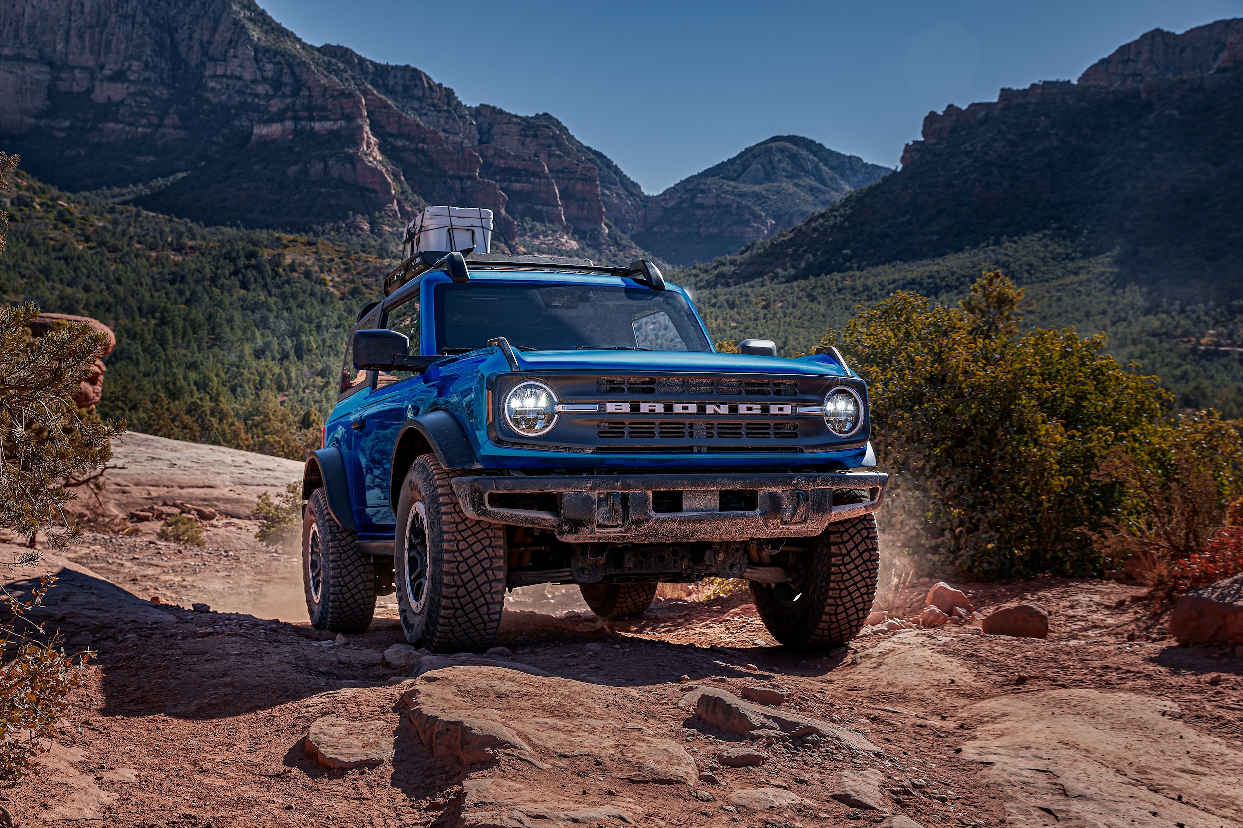 2025 Ford Bronco offroad with a cooler strapped on the roof