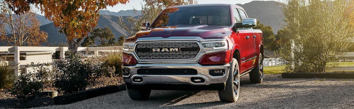 A red 2019 Ram 1500 driving onto a farm