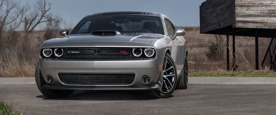 2019 Dodge Challenger A silver 2019 Dodge Challenger parked by a field