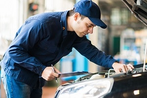 A dodge service technician looking at a vehicle