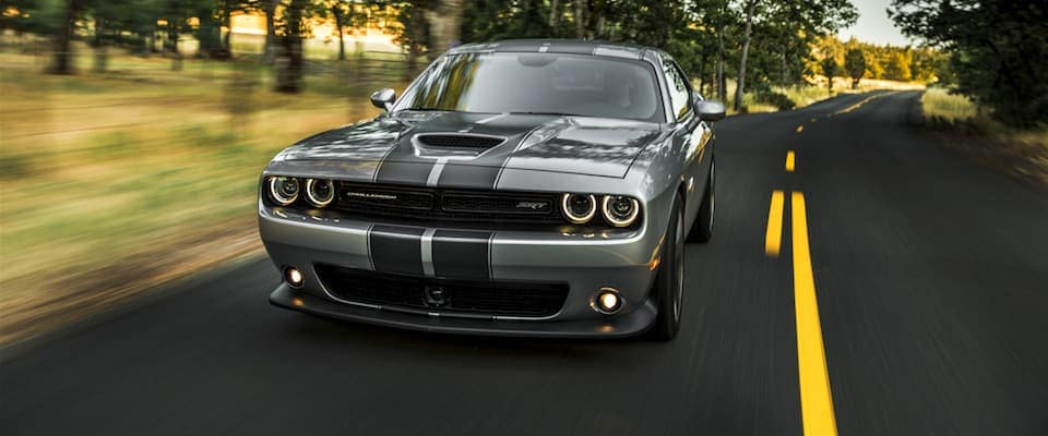 2019 Dodge Challenger A silver 2019 Dodge Challenger driving down an open country road