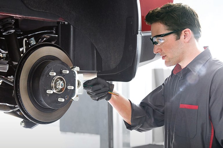 Service tech working on vehicle