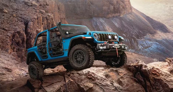 Blue 2026 Jeep Wranlger in rocky terrain
