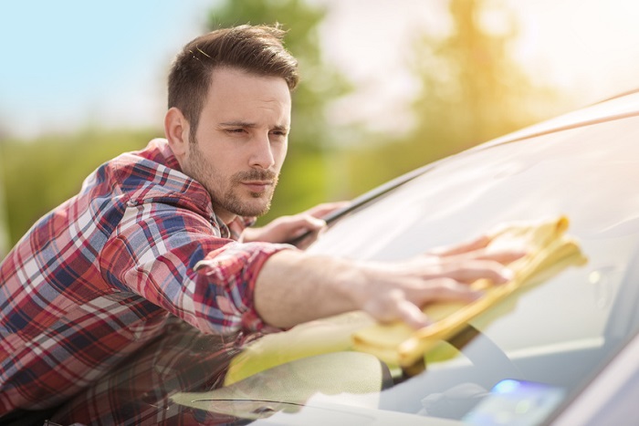 man cleaning windshield image