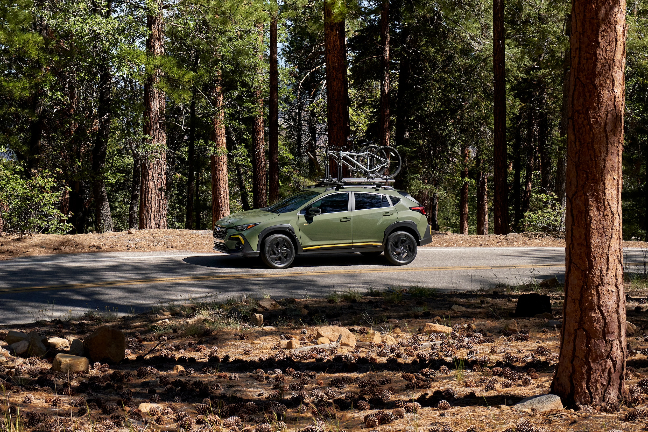 The 2026 Subaru Crosstrek driving through a forest