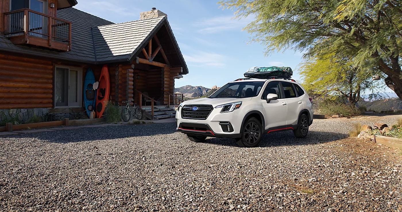 A Subaru Forester lease parked at a cabin