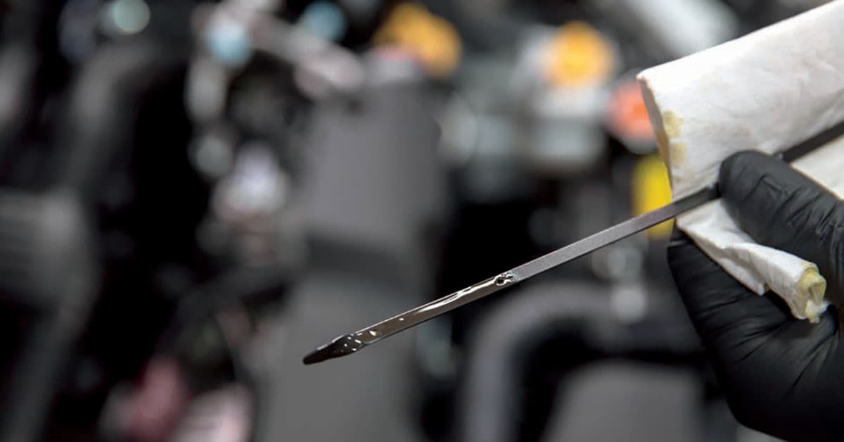 Performing an oil change as part of a Subaru service schedule