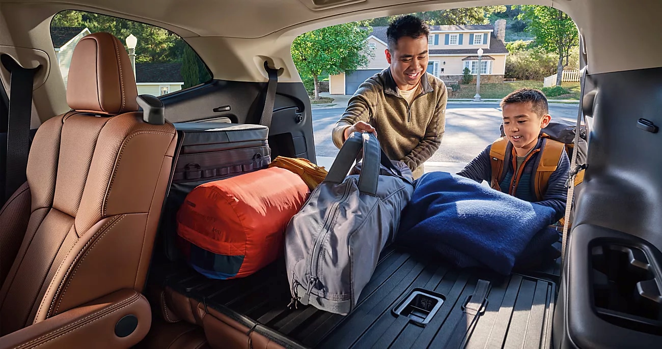 Dad and son loading the cargo area of the 2026 Subaru Ascent
