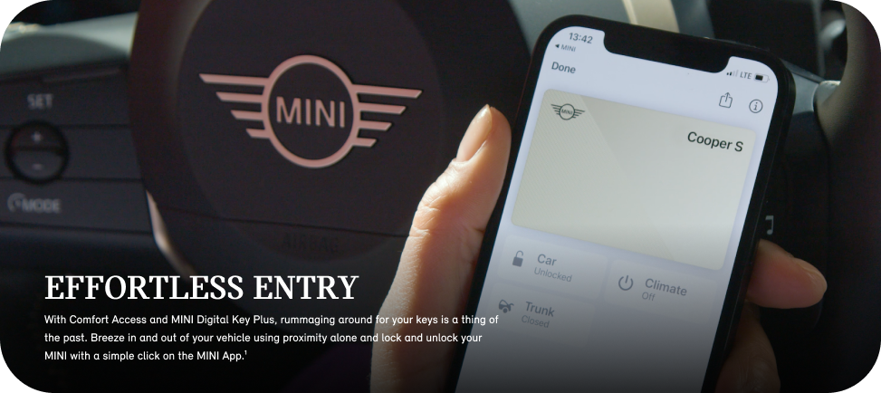 5.png A hand holding up a smartphone open to the
MINI App with a steering wheel in the background.