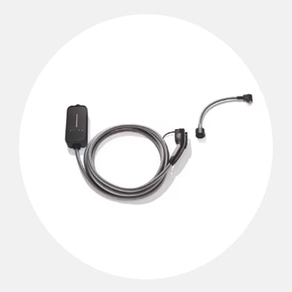 Electrical outlet on a white wall with a MINI Electric charger plugged into it. 