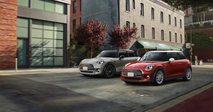 Two MINI's driving down the street