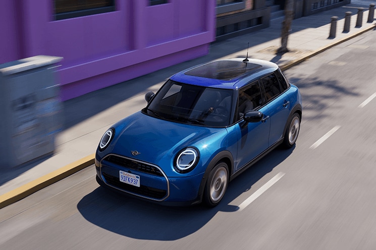 Blue MINI Cooper 4 Door driving in a city