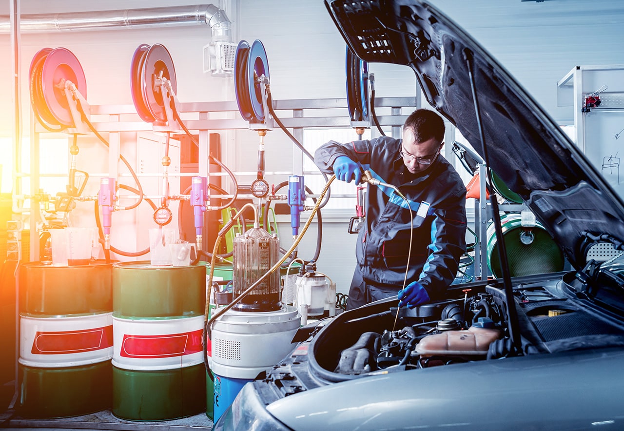 mechanic performing oil change
