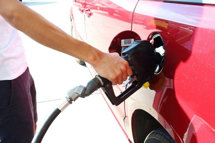 pumping gas into a red car