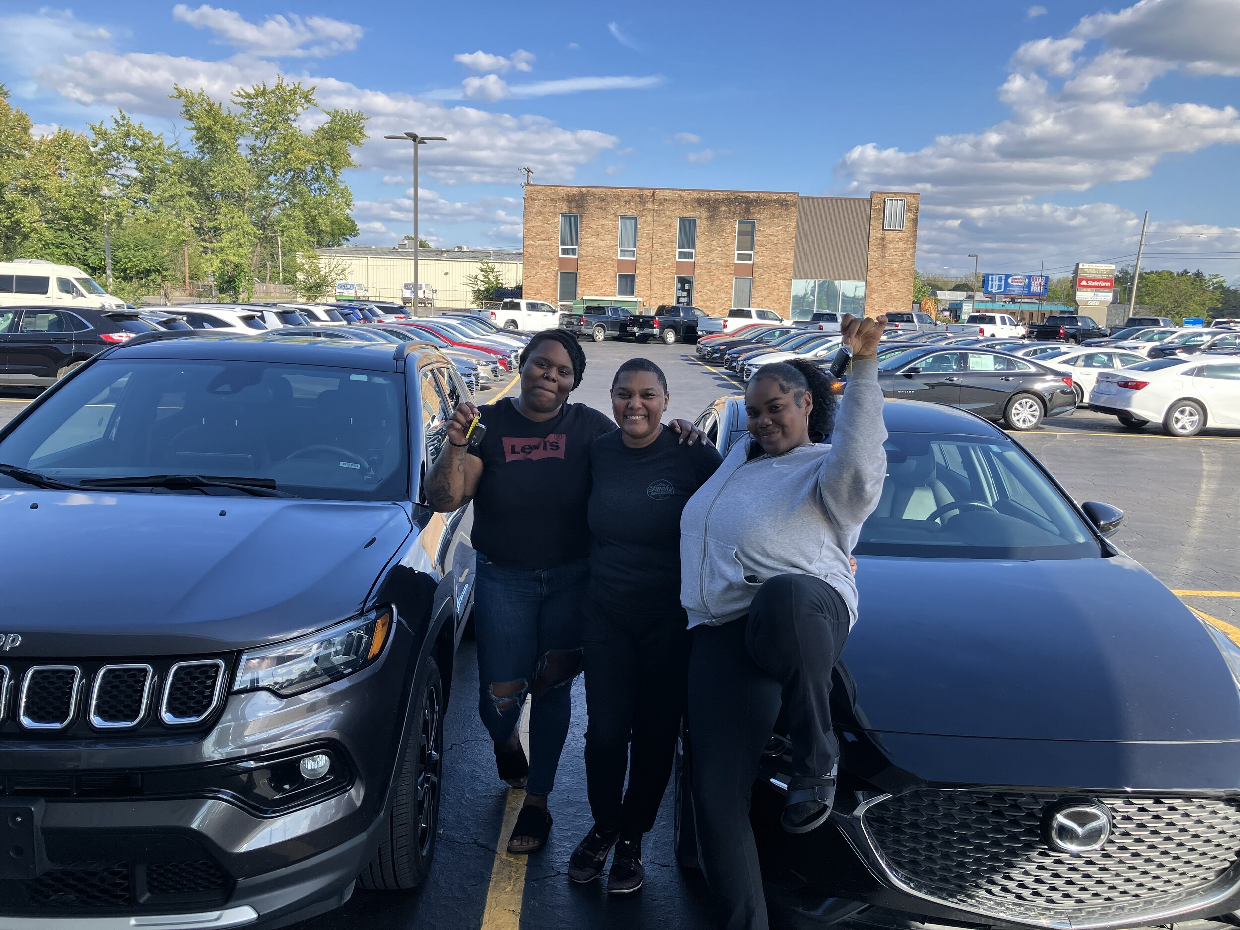 Happy Customers at Miracle Motor Mart with their used Jeep and used Mazda purchases.