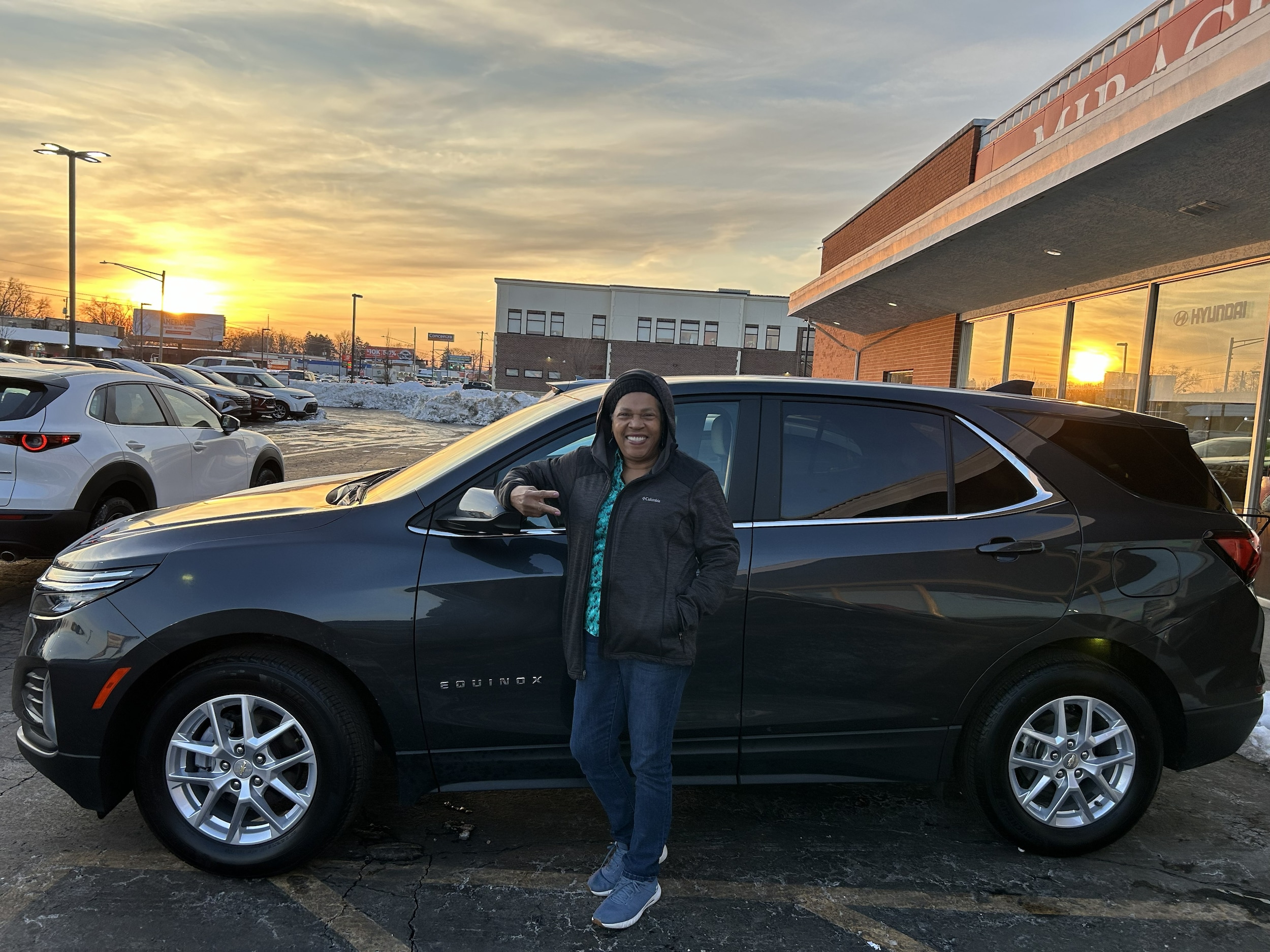 Happy Miracle Motor Mart customer with their used Chevy Equinox.