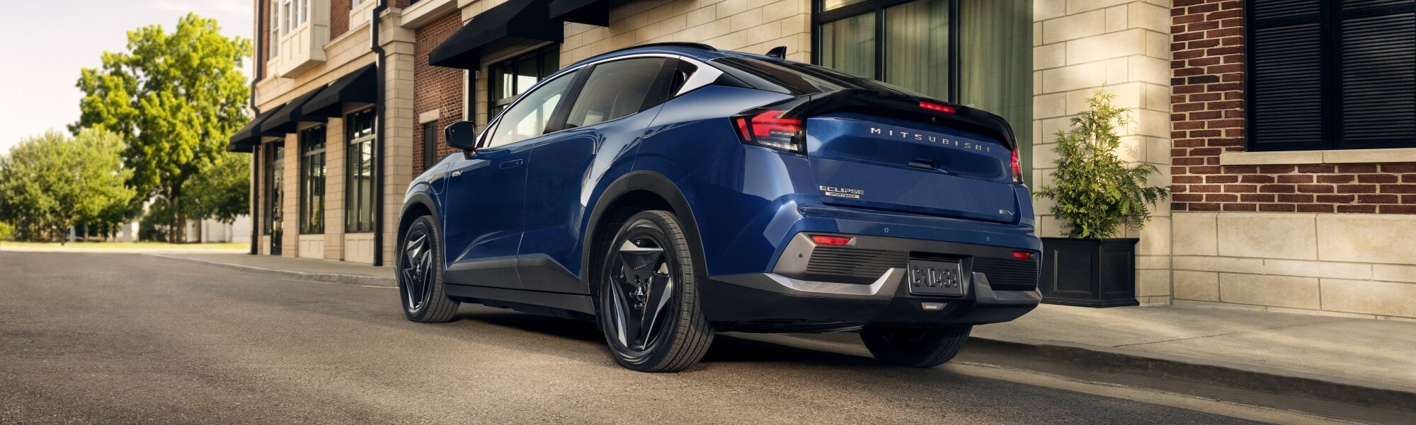 Back shot of a blue 2027 Eclipse Sportback EV parked in a city