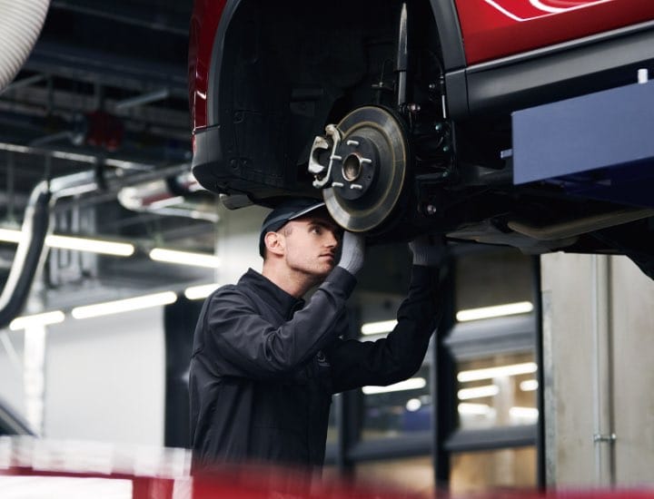 Technician inspecting brakes