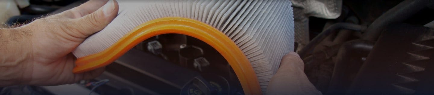 Technician Flexing Orange Air Filter