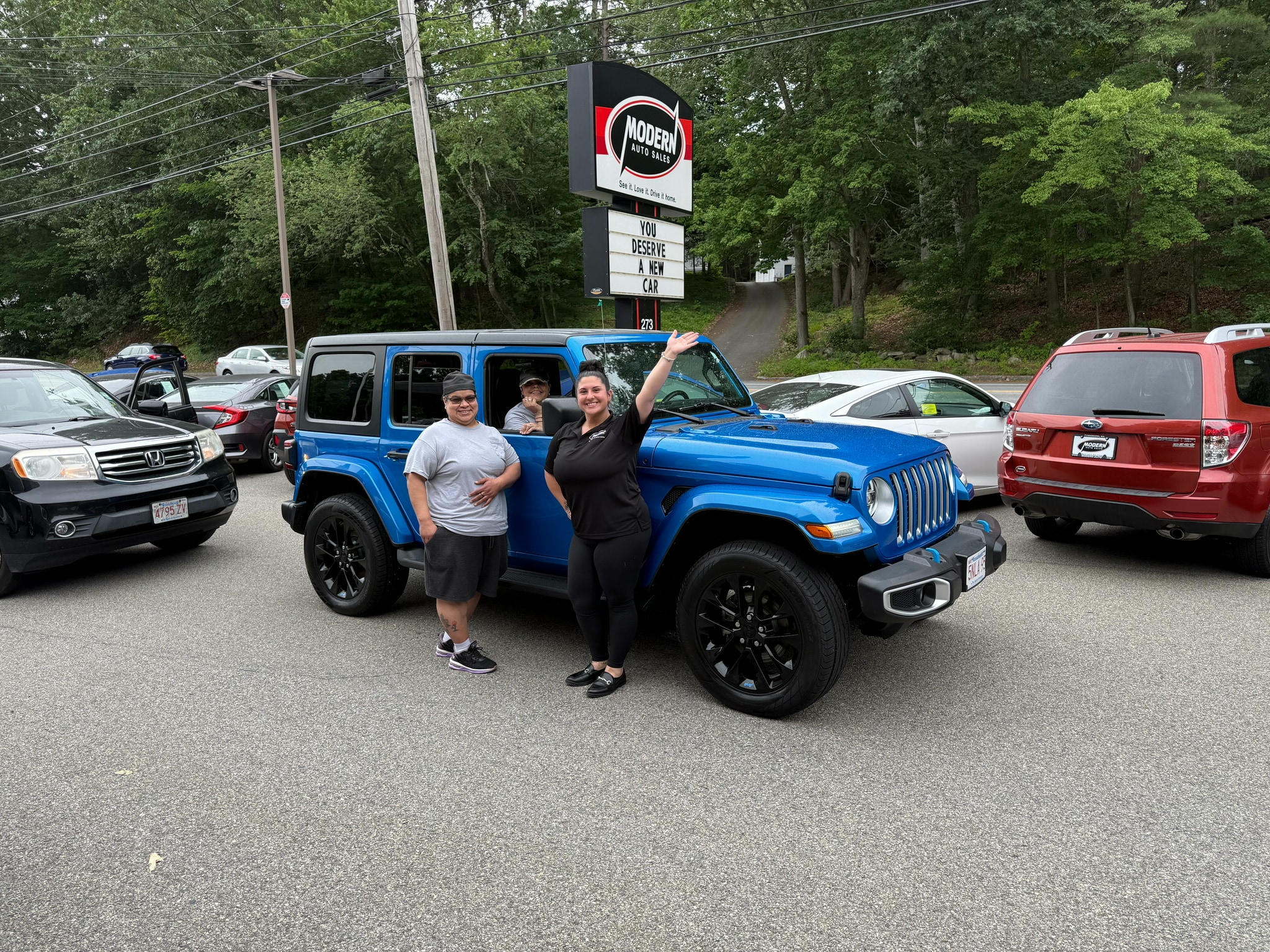Happy Modern Auto Sales customer with new vehicle