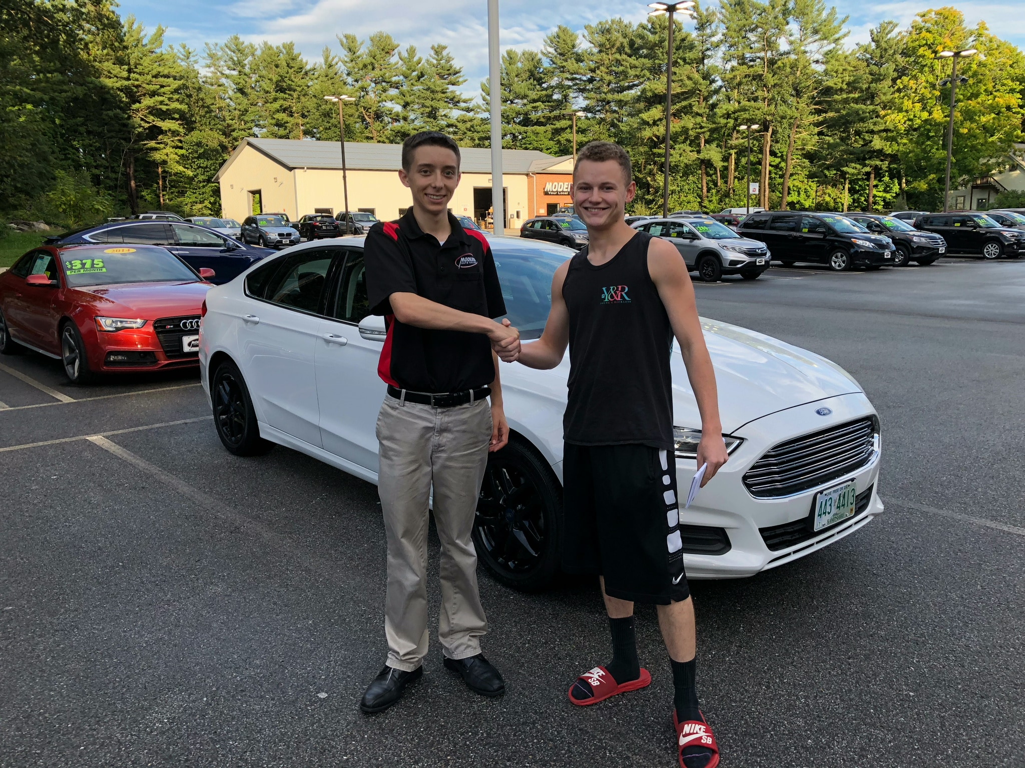 Happy Modern Auto Sales customer with new vehicle
