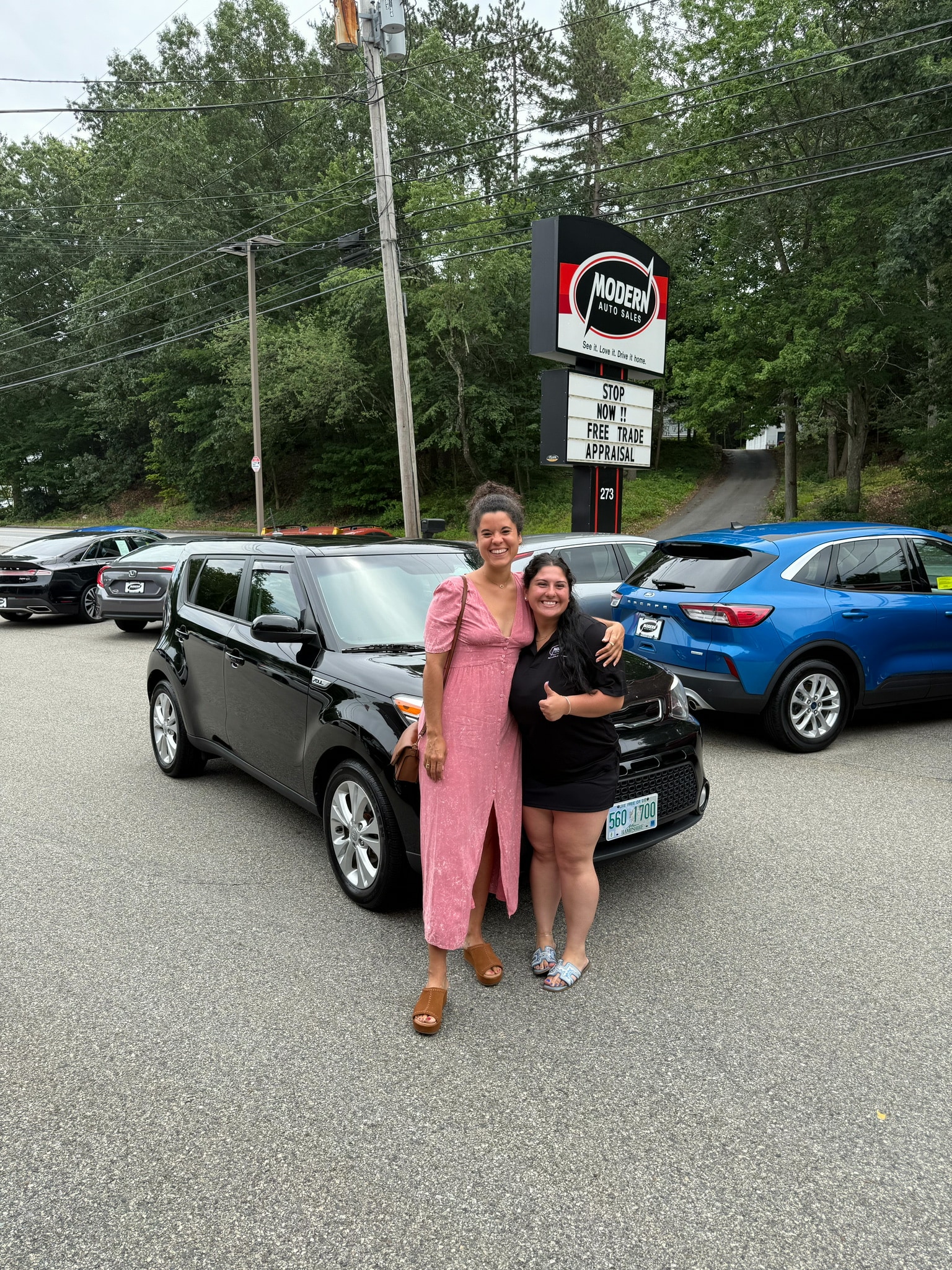 Happy Modern Auto Sales customer with new vehicle