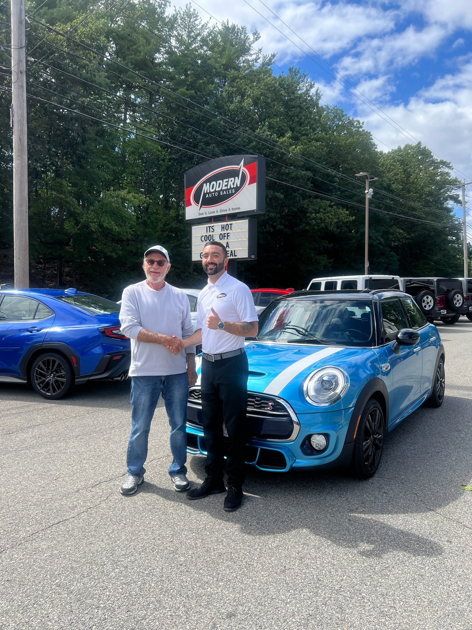 Happy Modern Auto Sales customer with new vehicle