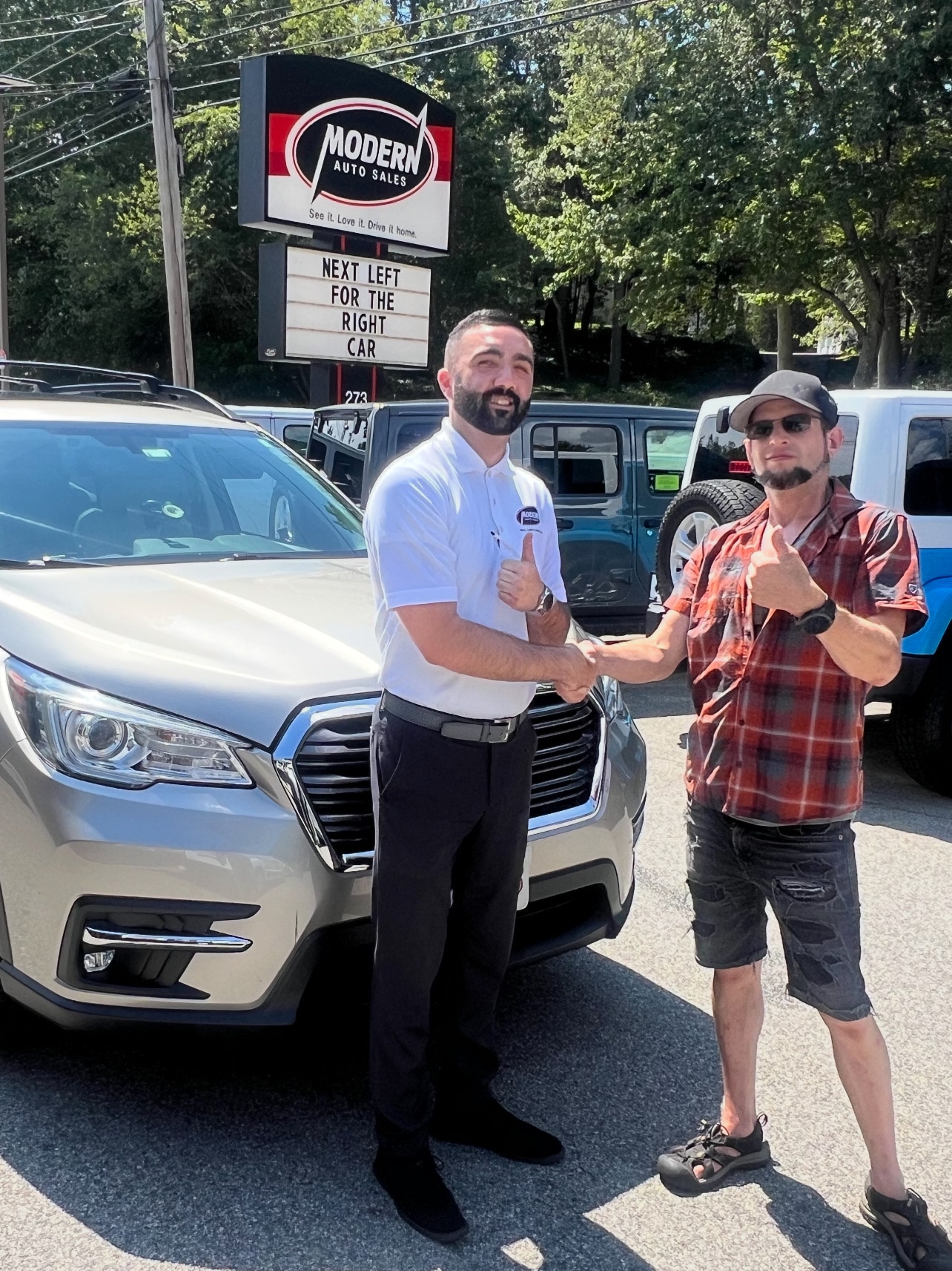 Happy Modern Auto Sales customer with new vehicle