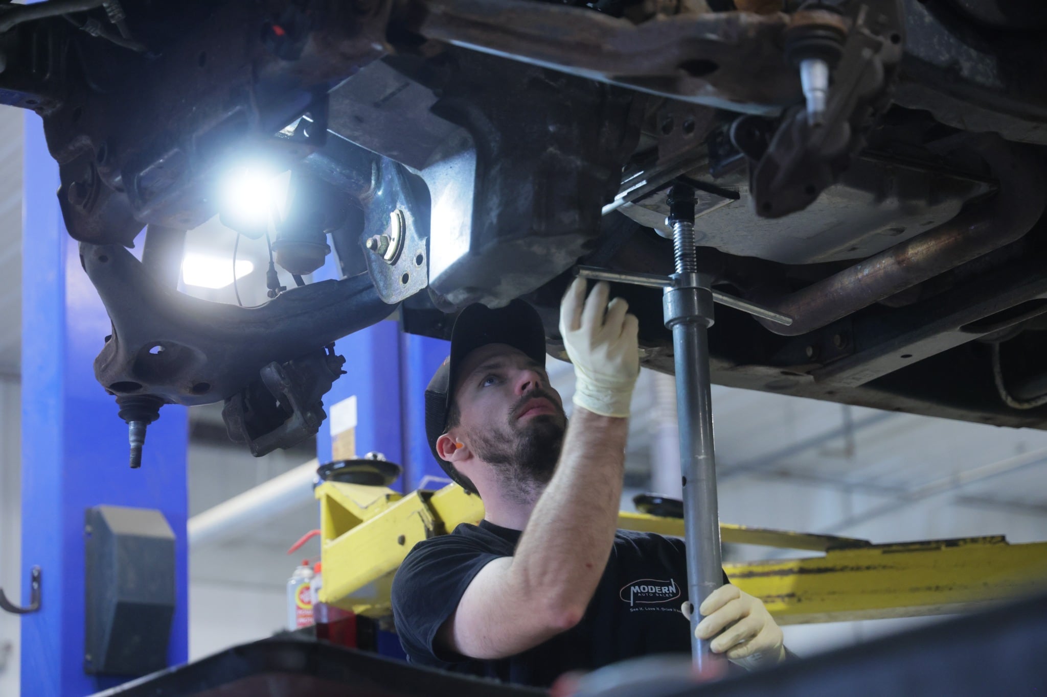 Modern Auto Sales technician inspecting a vehicle