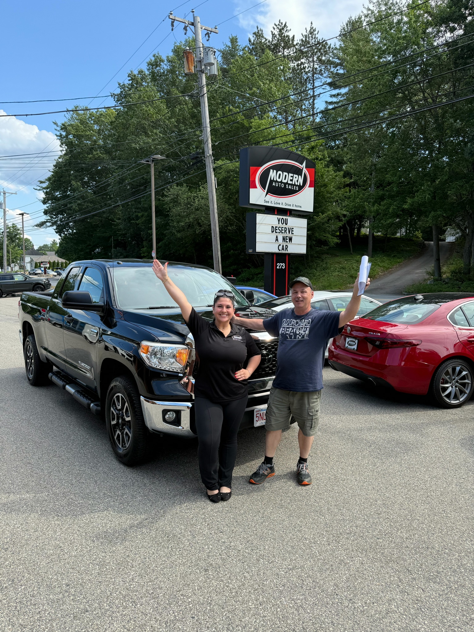 Happy Modern Auto Sales customer with new vehicle
