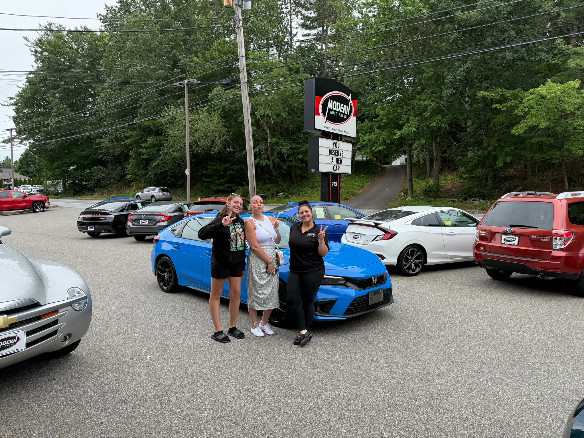 Happy Modern Auto Sales customer with new vehicle