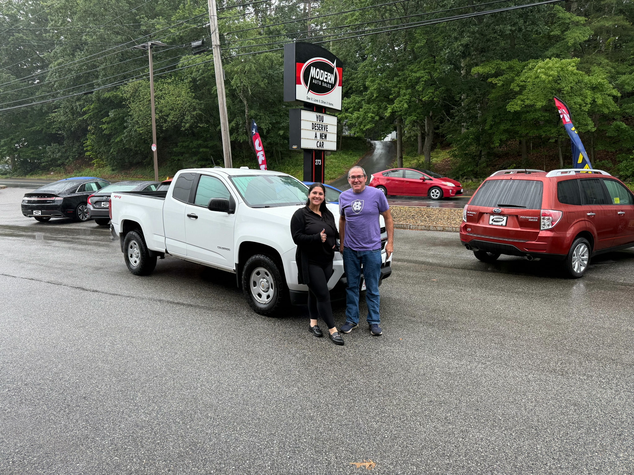 Happy Modern Auto Sales customer with new vehicle