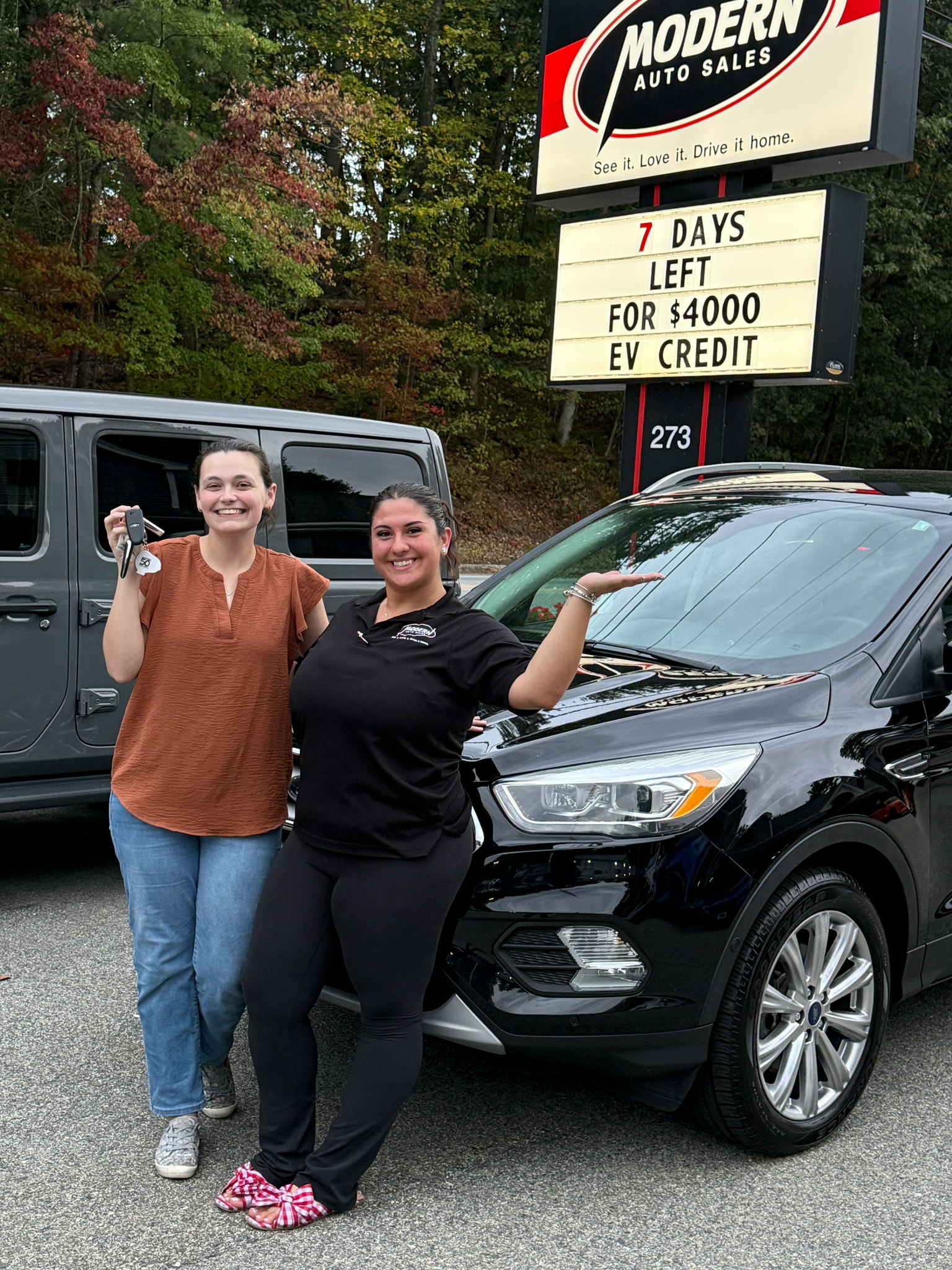 Happy Modern Auto Sales customer with new vehicle