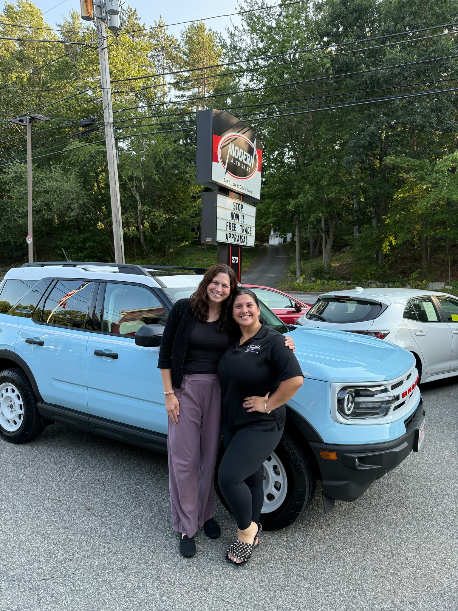 Happy Modern Auto Sales customer with new vehicle