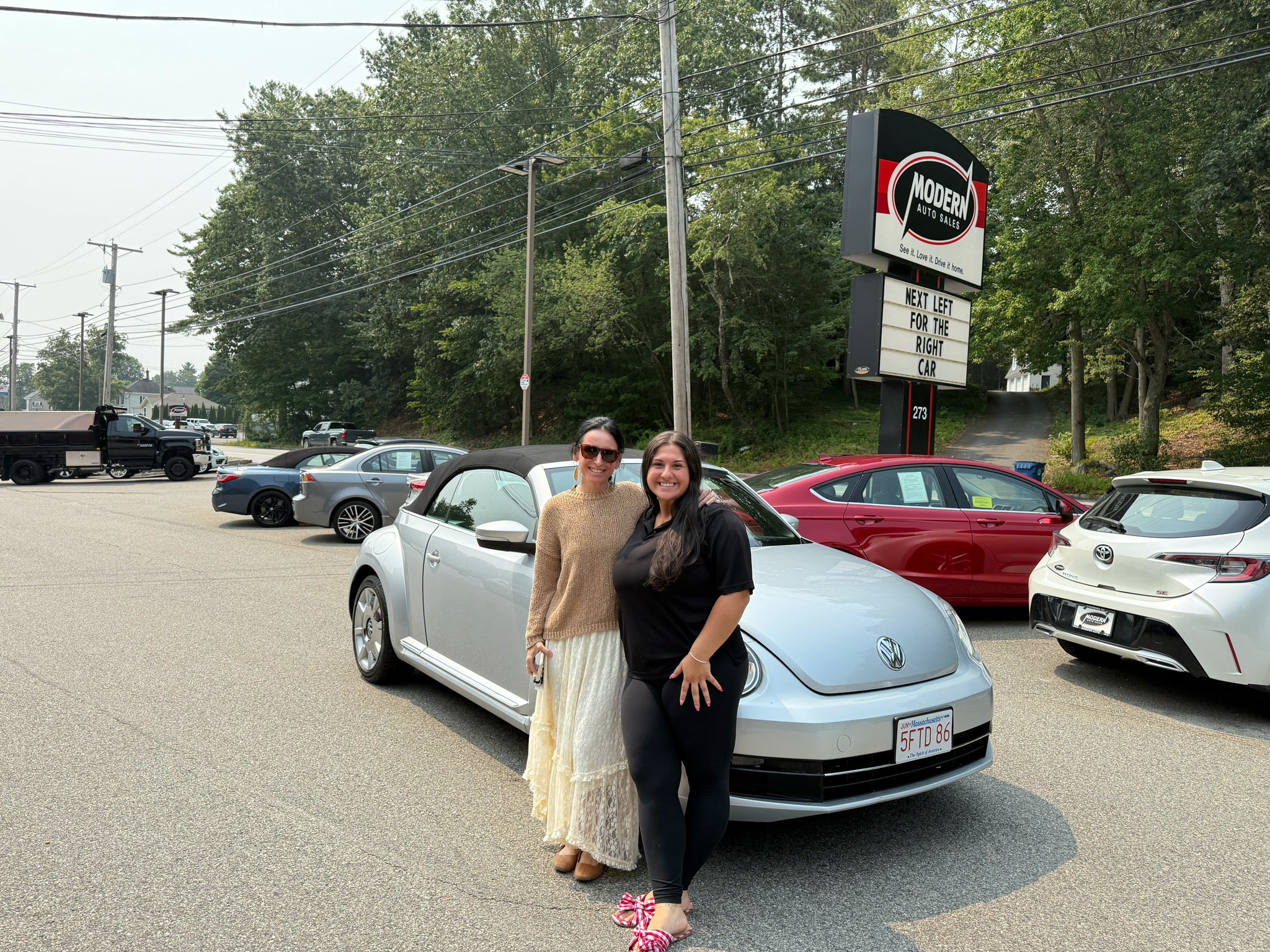 Happy Modern Auto Sales customer with new vehicle