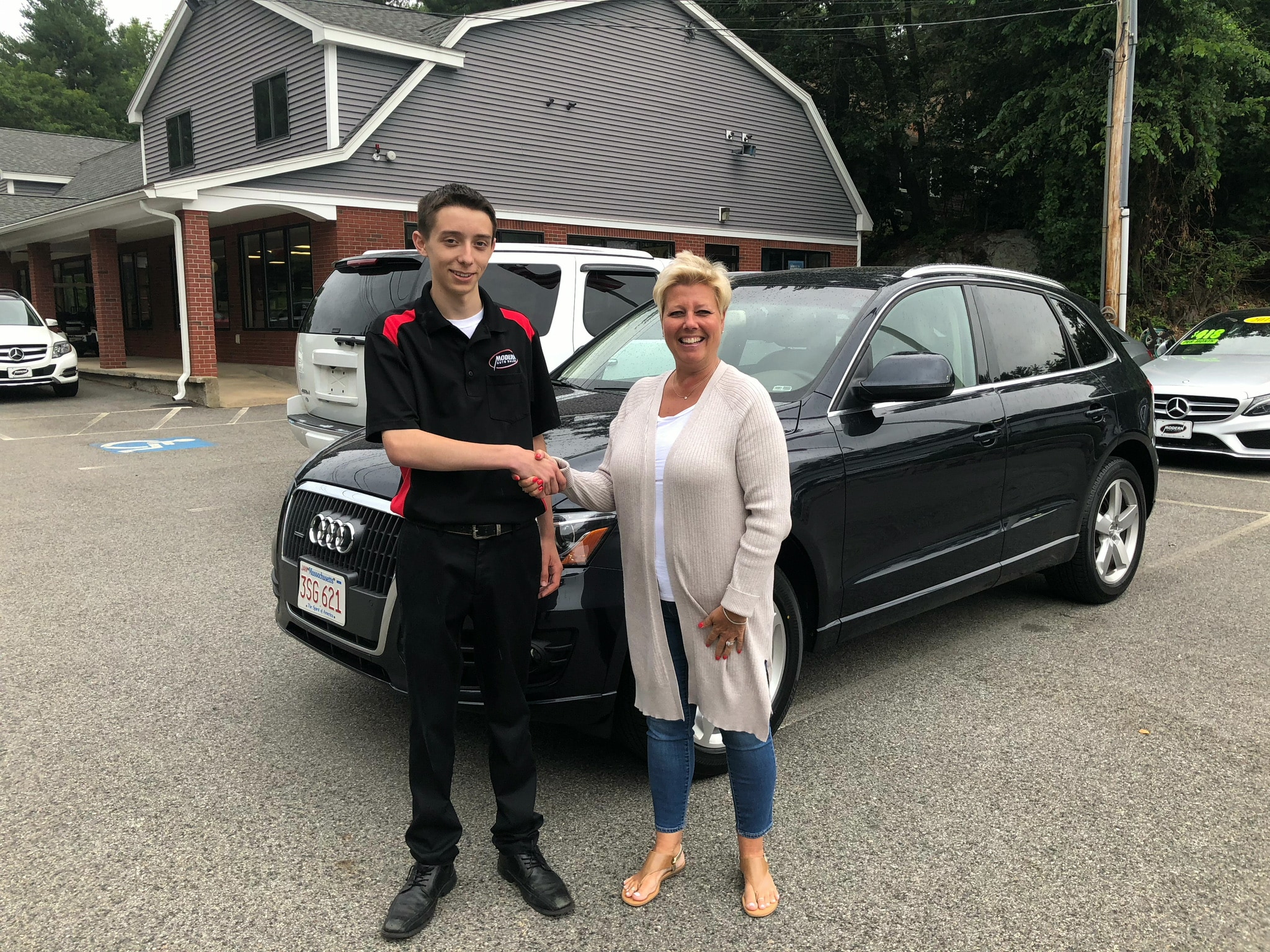 Happy Modern Auto Sales customer with new vehicle
