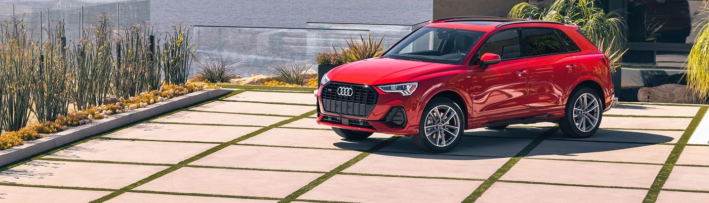 Red Audi Q3 S Line parked by the ocean