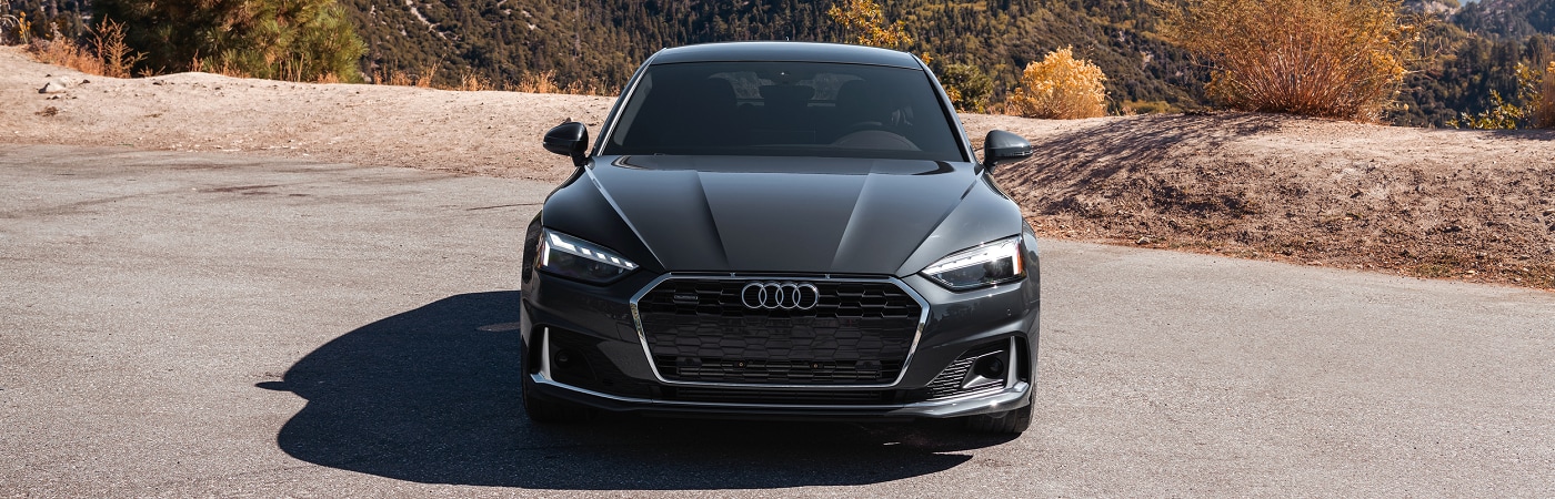 Audi A5 Sportback parked near a mountain