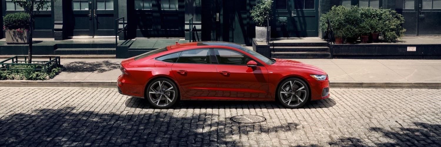 Red Audi A7 Premium parked on a city street