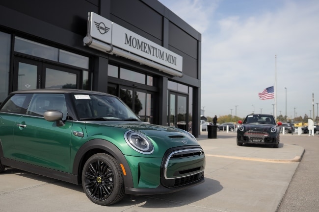 Momentum MINI Momentum MINI dealership front door with MINI SUVs parked outside