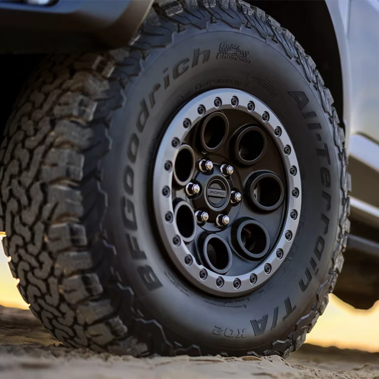 Close-up of the 37-inch wheel and all-terrain tires of a 2026 Ford
F-150® Raptor® truck.