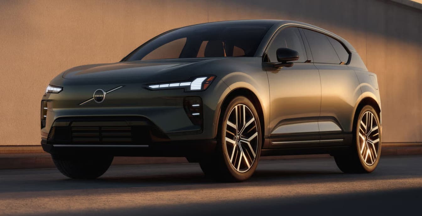 Sleek, modern 2026 Volvo EX60 SUV with metallic finish parked in low sunlight.