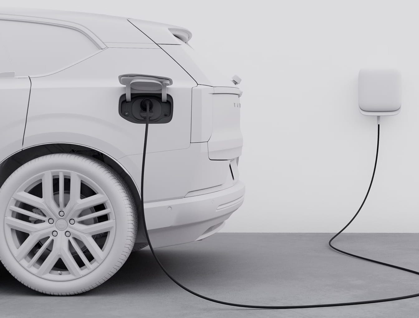 A white electric car is charging in a minimalist setting, connected to a wall-mounted charger.