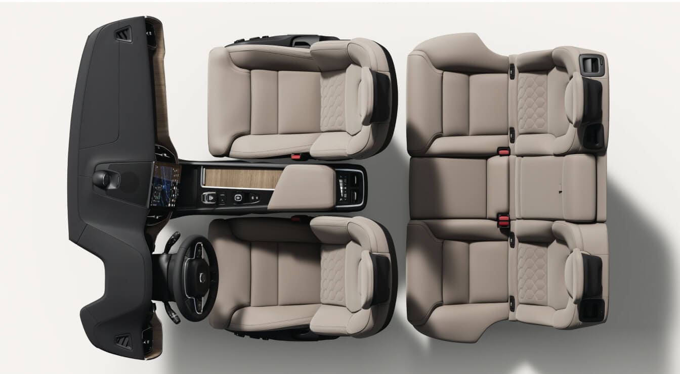 Top-down view of a Volvo XC60 Plus interior layout showcasing cardamom nordico seats, dashboard, and center console.