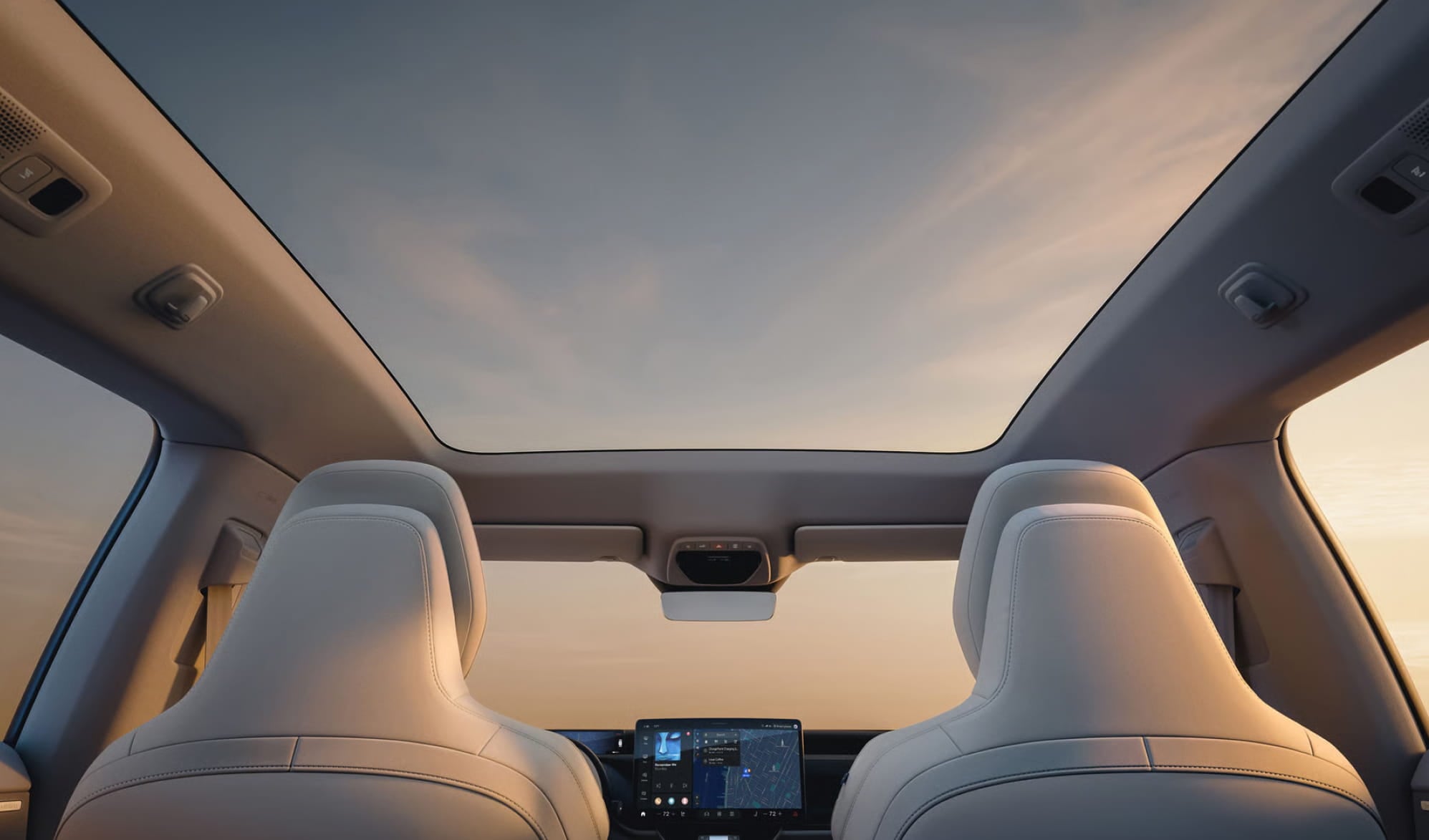 View from the back seat of a 2027 Volvo EX60 interior with white leather seats.