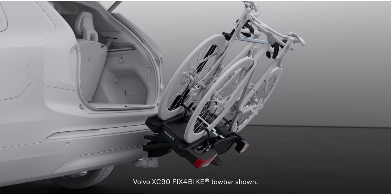 Rear studio view of a Volvo XC90 Ultra with an open tailgate and a tilted FIX4BIKE towbar bicycle rack.