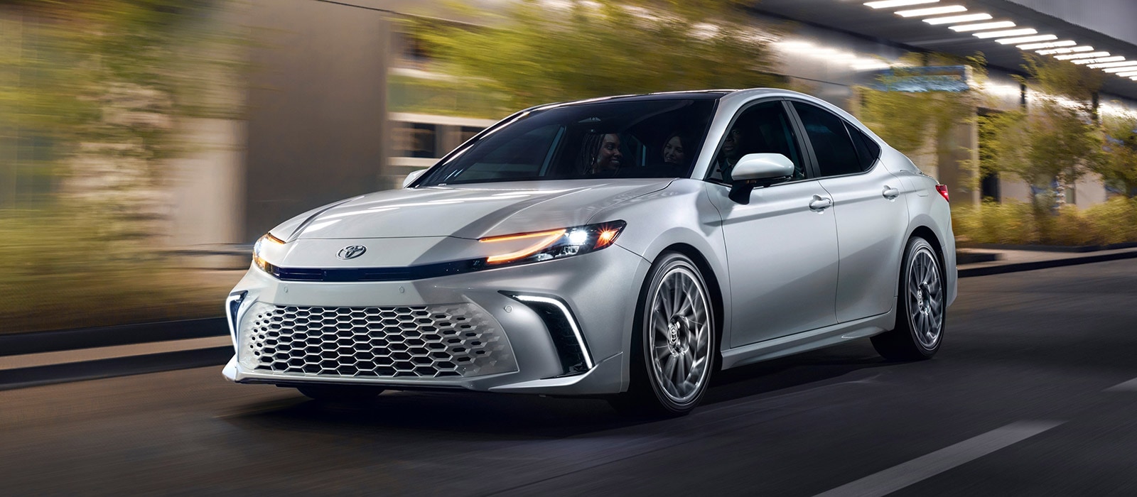 2026 Toyota Camry driving on a well-lit city road