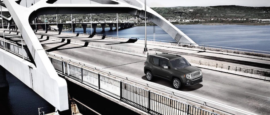 A 2018 Jeep Renegade driving over a bridge