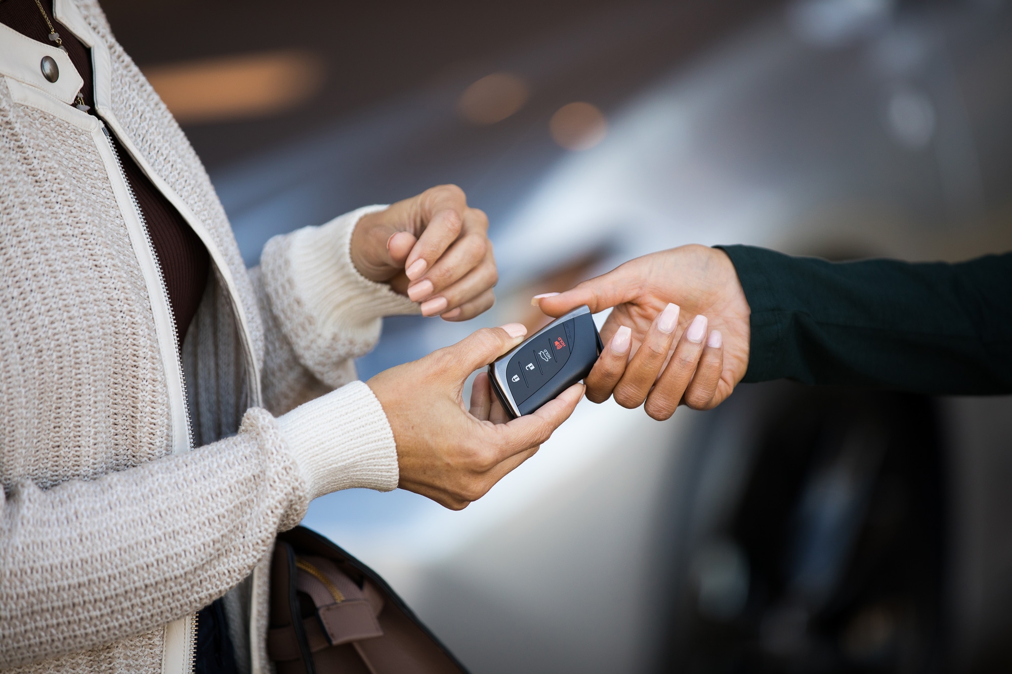 Lexus dealer handing car key to customer