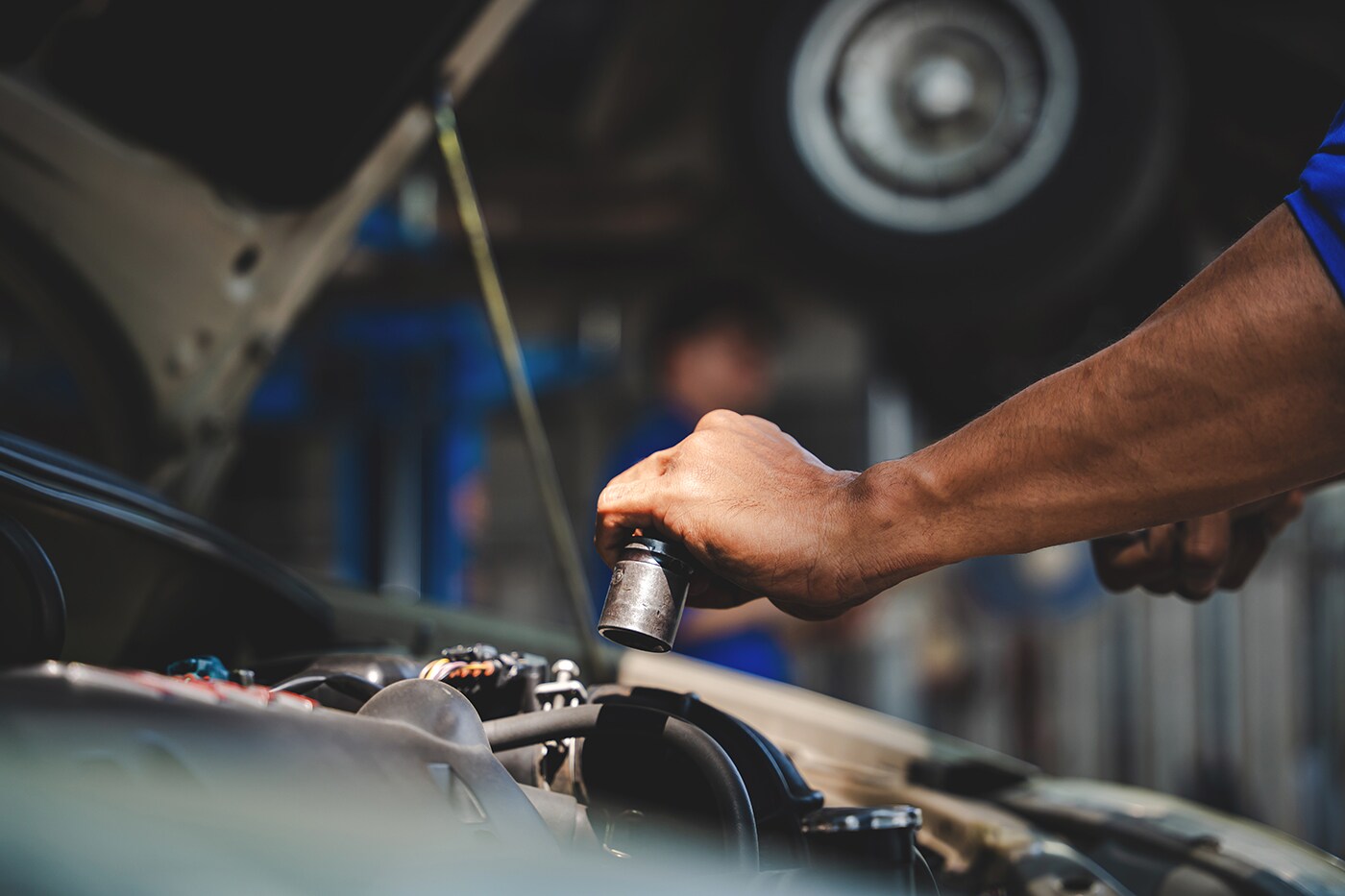 Man Working on a Car in an Auto Repair Shop
